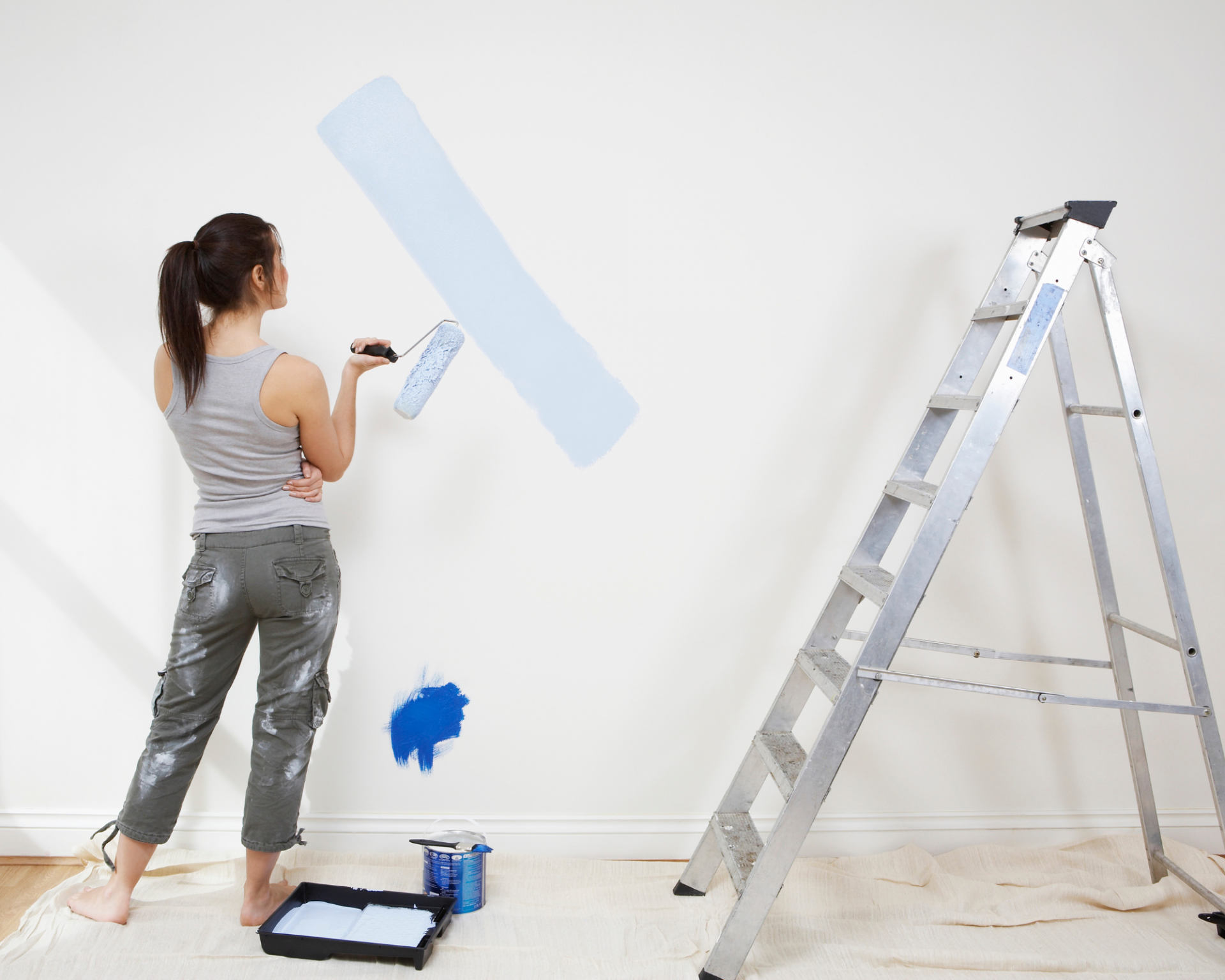 Woman painting a room in her house