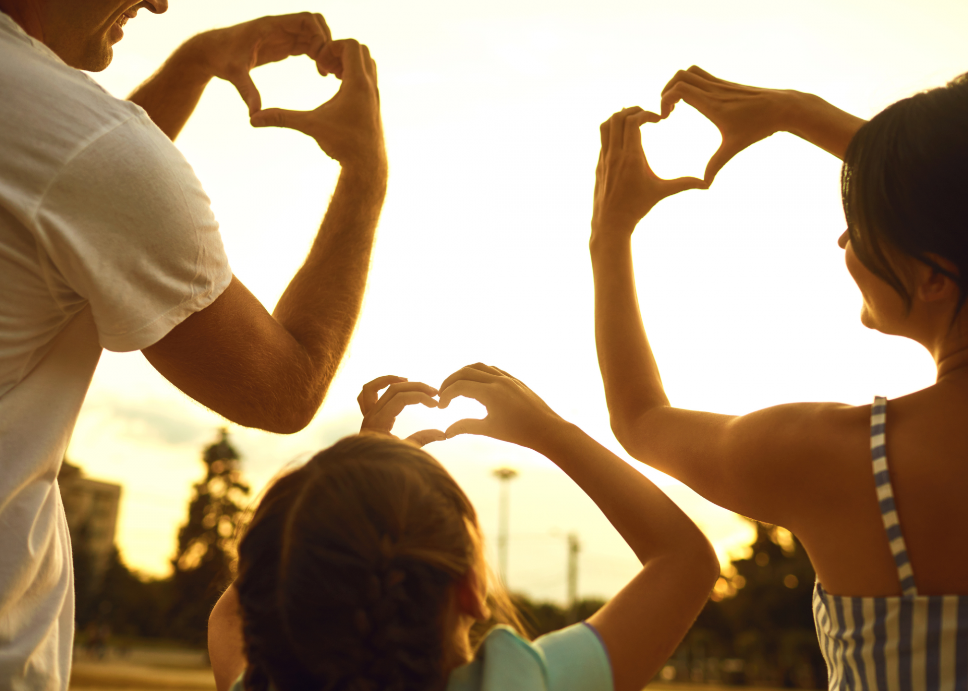 A family making hearts with their hands