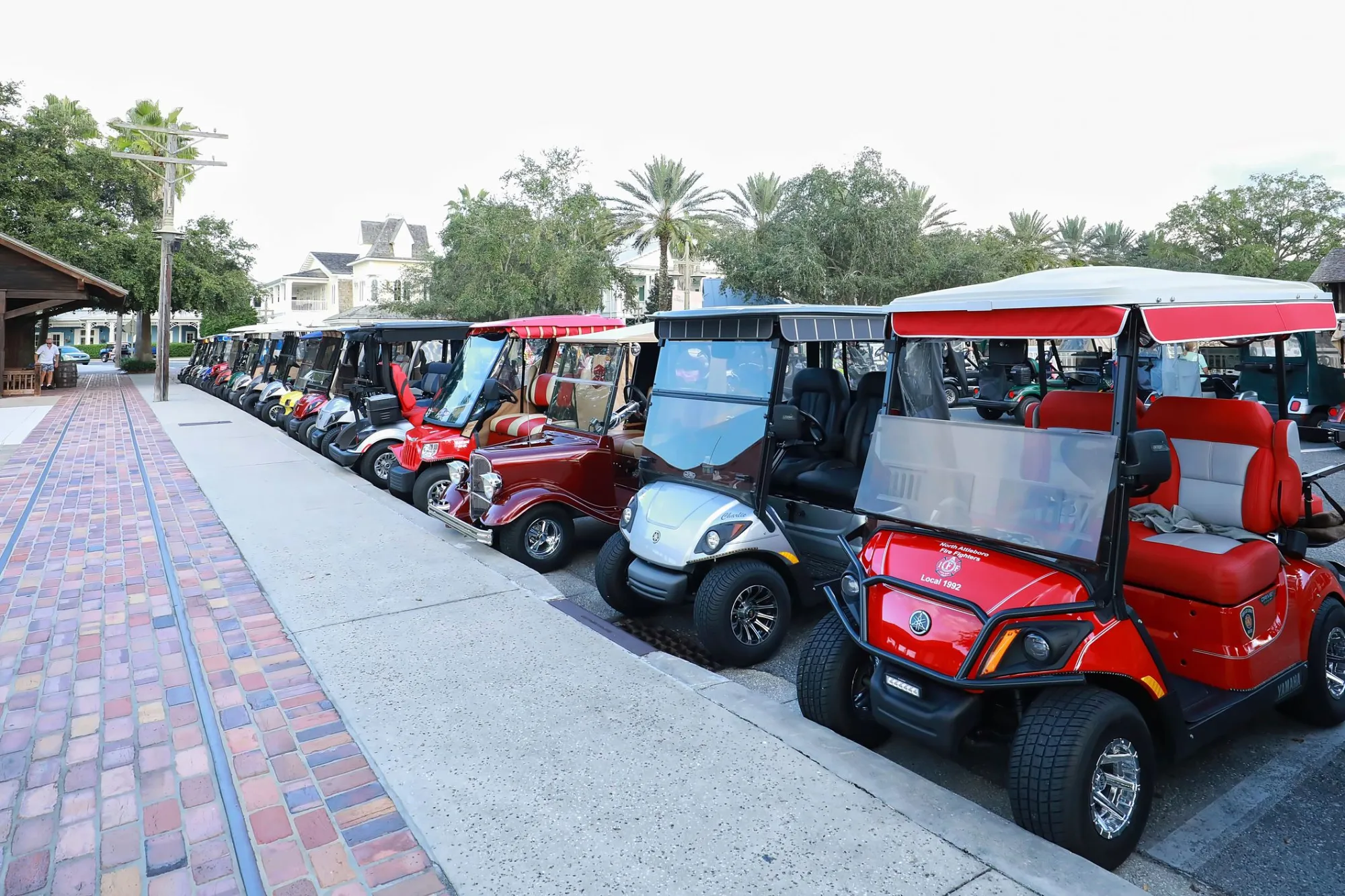 Golf carts parked along a brick sidewalk in downtown Winter Garden, Florida