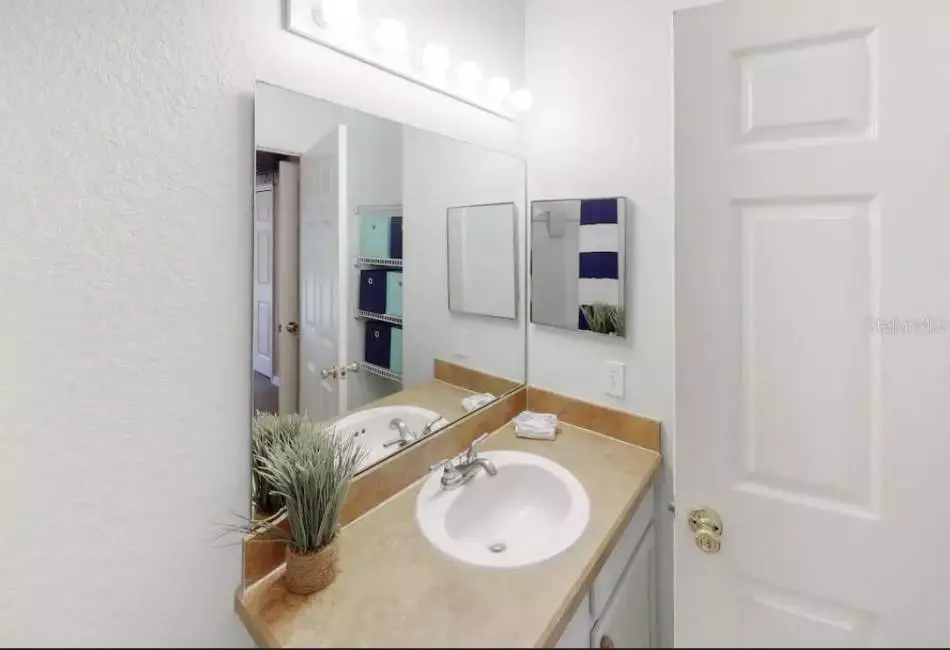 Master bathroom tub with a shower, ceramic tile