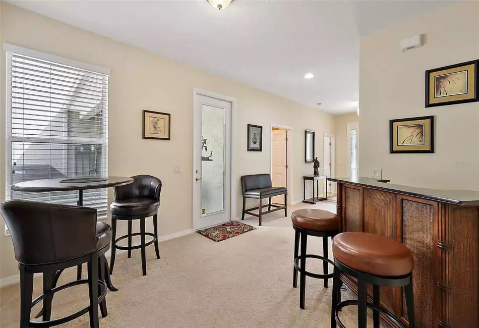 This Unique Entertainment Area is an extra  plus  for when you have friends over for drinks and snacks...   French Door and Windows look out to the Spacious Court Yard. Other doors on left side are Hall Bath & 2nd Bedroom/ Office or In-Law Suite