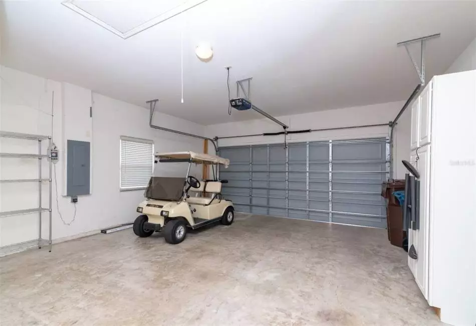 2 Car Garage with golf cart that conveys with home