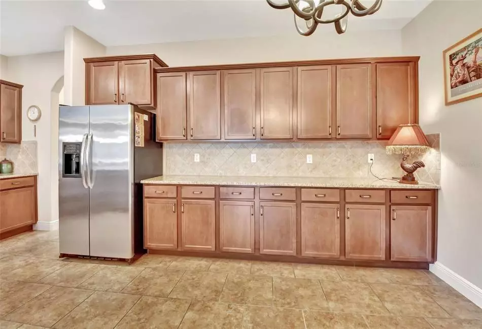 Casual dining area in kitchen and loads of cabinets and counter space.