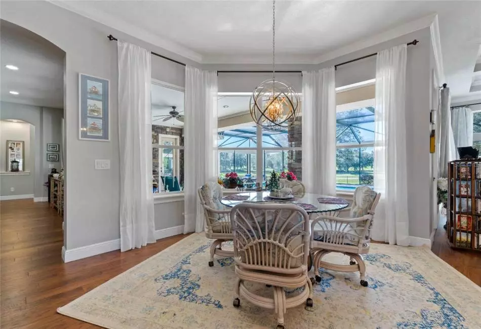 Eat-in-Kitchen area with bay window overlooking pool and golf course.