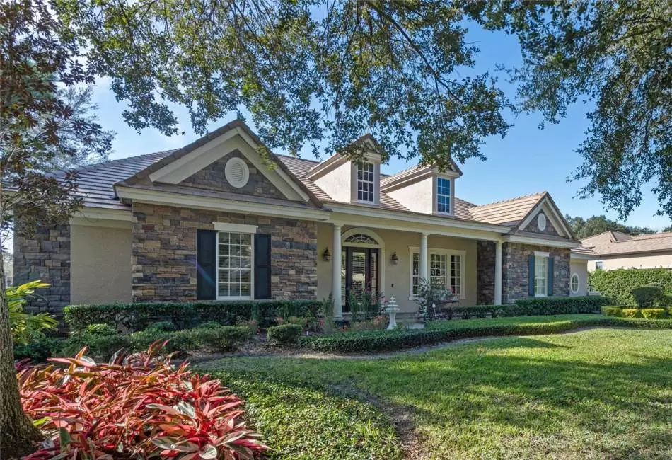 Elegant roman columns and a welcoming front porch are just the beginning of the wonderful curb appeal that makes this home so enviable.