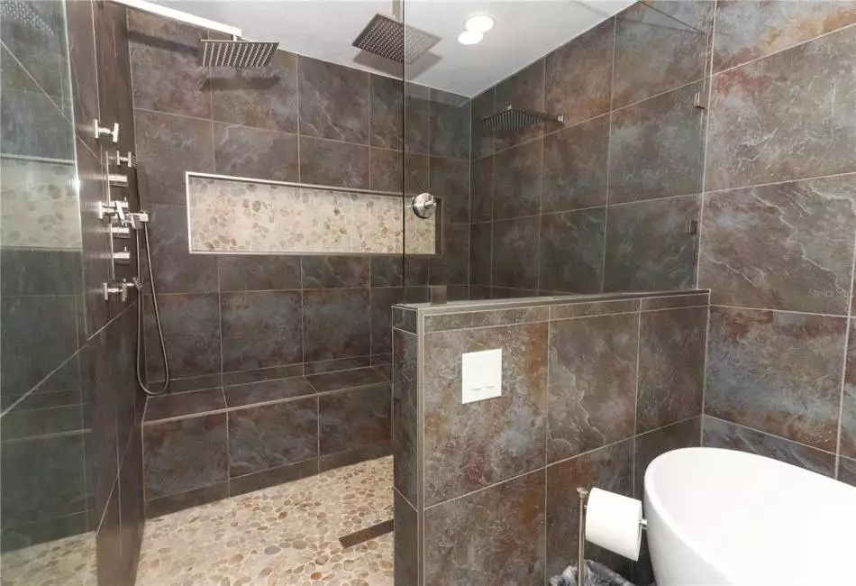Spacious walk in shower with dual shower heads and rain shower