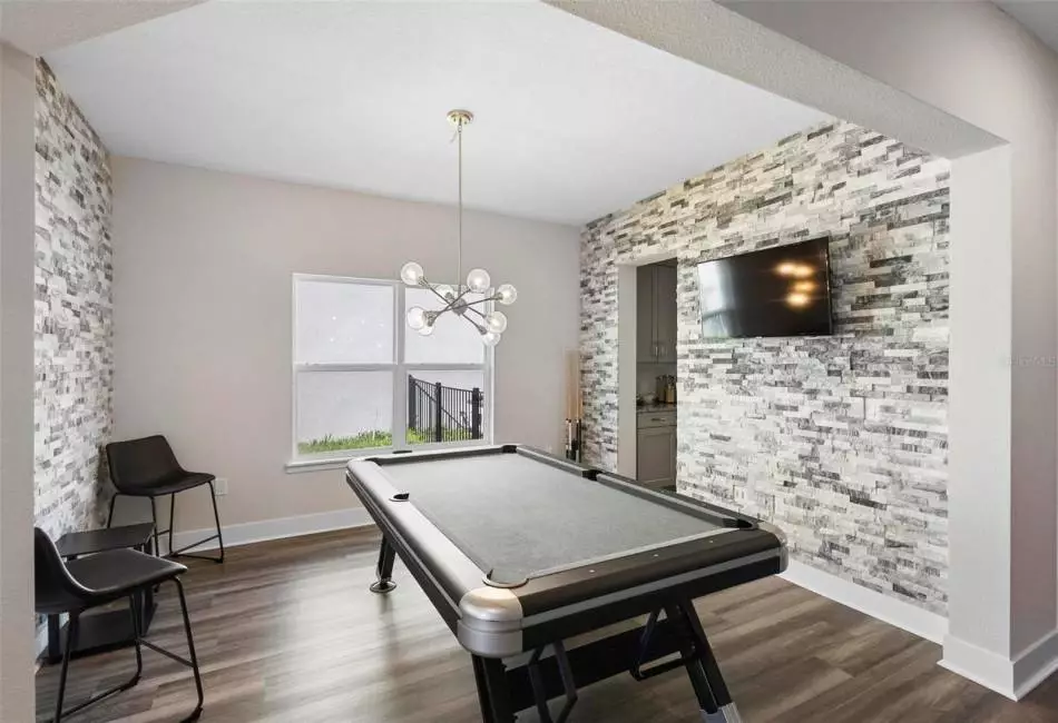Game room/Dining room with accent stone walls