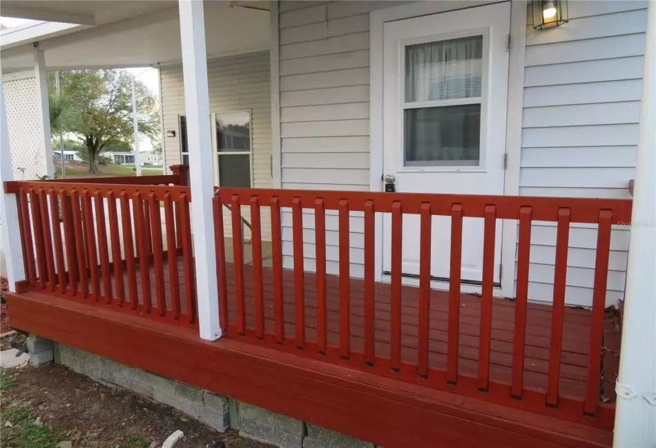 Side porch/deck provides access into property