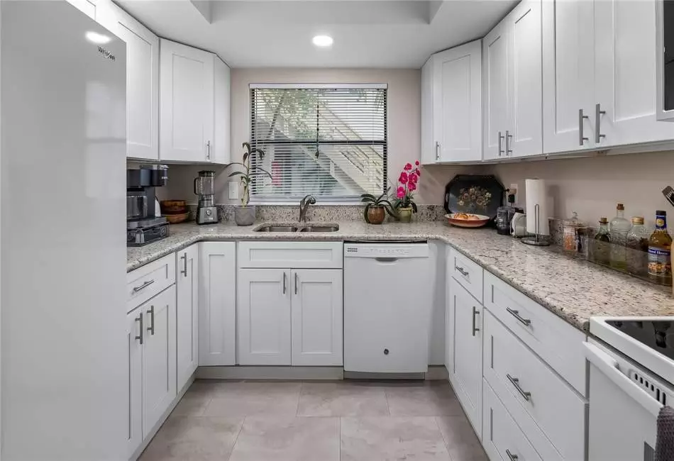 Beautifully renovated kitchen, granite countertops, soft-close doors and drawers and recessed lighting. Large window above sink to view the courtyard. Most appliances are less than 2 years old along with a bluetooth microwave.