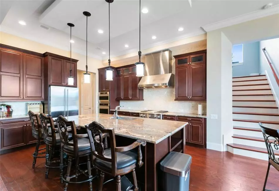 Featuring granite countertops, stainless steel appliances and a tile backsplash.