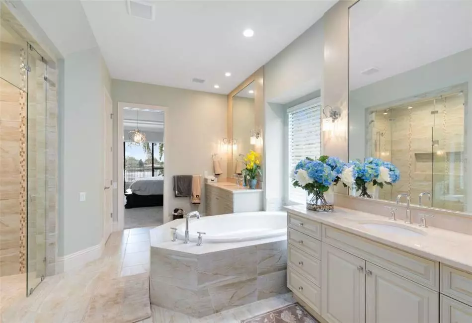 You'll enjoy separate vanities with ample counter and cabinet space along with a luxurious soaking tub.