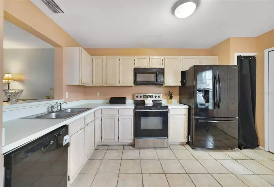 The kitchen offers ample cabinet and counter space, pantry and in-unit laundry!