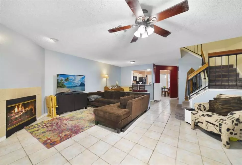 The combination living and dining areas are tiled for easy maintenance and the living room features a cozy FIREPLACE with tile surround and a DOUBLE SET OF SLIDING GLASS DOORS for fantastic natural light and access to the SCREENED LANAI!