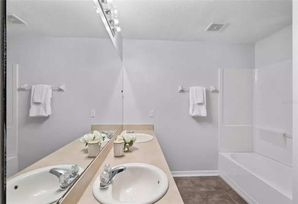 Full Bath: Located adjacent to bedroom #2. Double Sink, Tile flooring, Shower Tub Combo, Enclosed Toilet