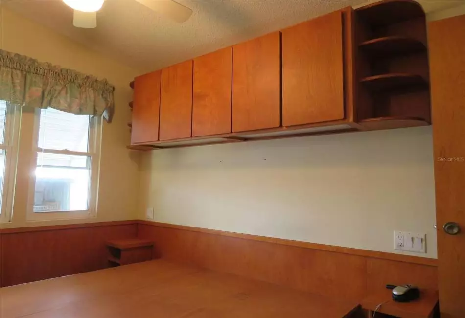 Built in bed base and overhead cabinets provide beauty and additional storage space