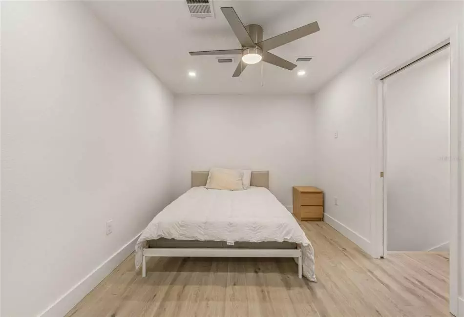 Upstairs bedroom with ensuite bathroom and ceiling fan
