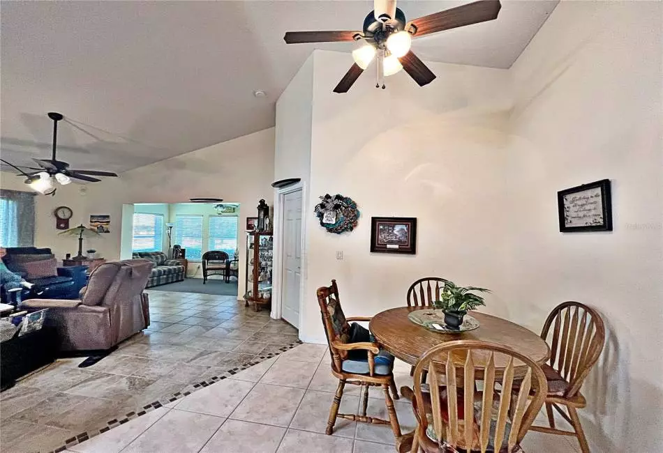 Dining room with view of Living Room, enclosed lanai, vaulted ceilings