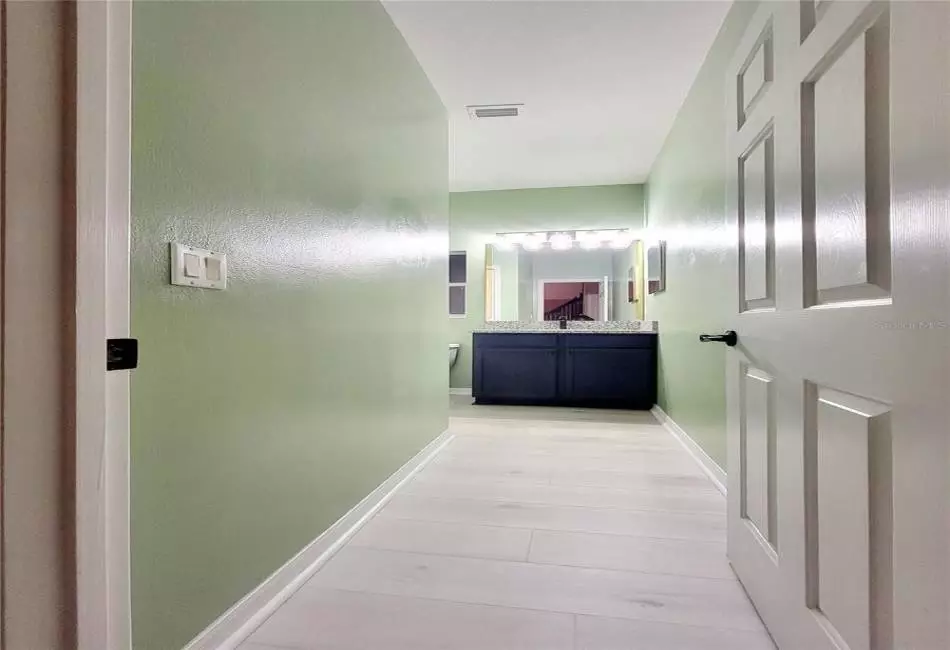 1st Floor half bathroom with Designer Fixtures, Upgraded Lighting and Granite Counters.