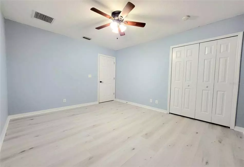Bedroom 2 with Large Spacious Closet, Ceiling Fan and Luxury LVP Floors.