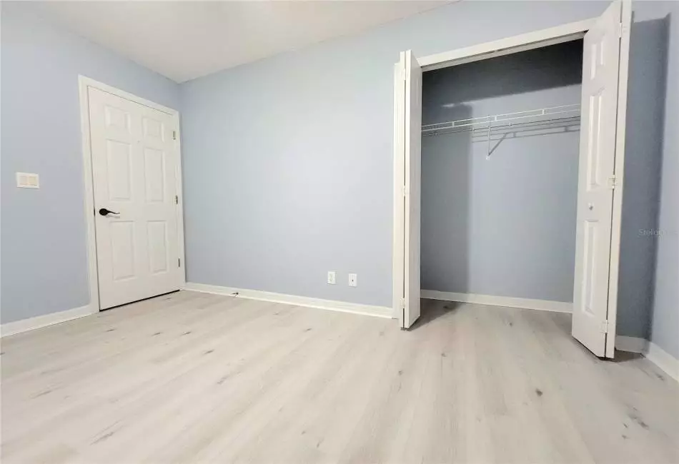 Bedroom 2 with Large Spacious Closet, Ceiling Fan and Luxury LVP Floors.