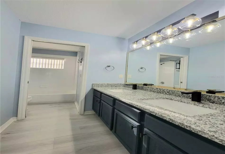 2nd Full Bathroom with separate shower with tub, lavatory, and large vanity with dual sinks, Upgraded Designer Fixtures and Lighting, and Luxury LVP Floors.