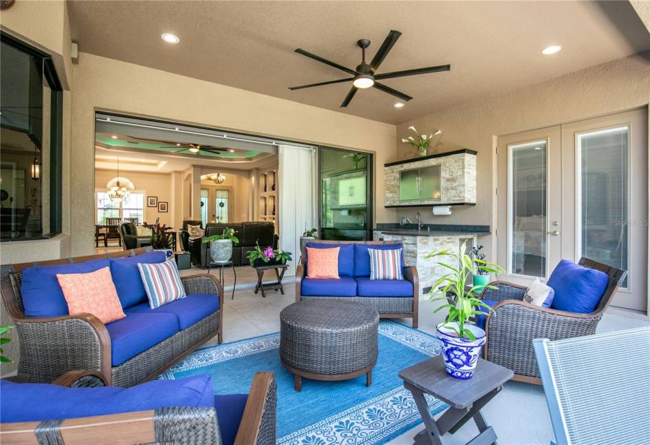 Living area extends with pocket door open to screened lanai