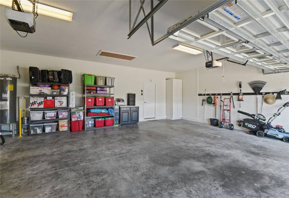 Spacious three car garage. Shelving and storage stays.