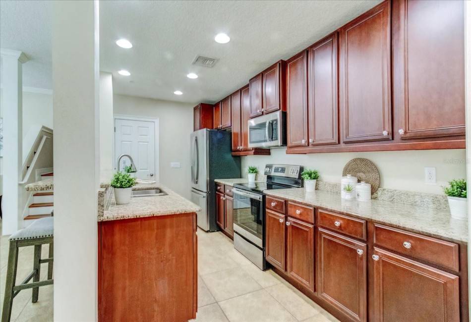 Wood cabinets, granite counters and stainless steel appliances.