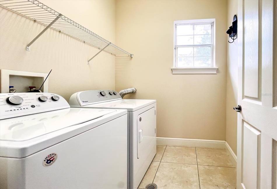 Upstairs laundry room with storage.