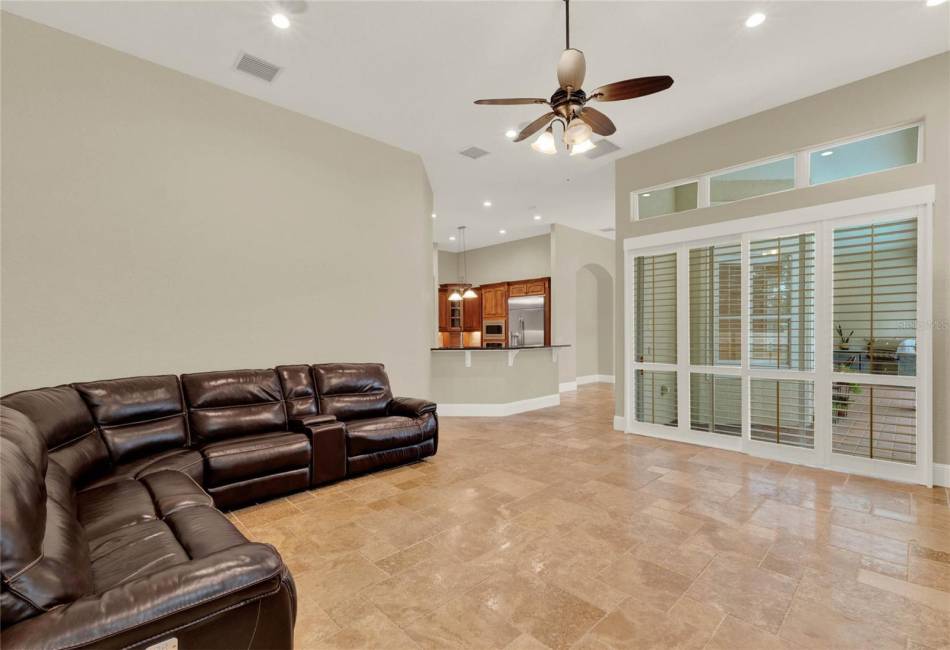 Family Room with sliders to access lanai, summer kitchen and pool/spa.