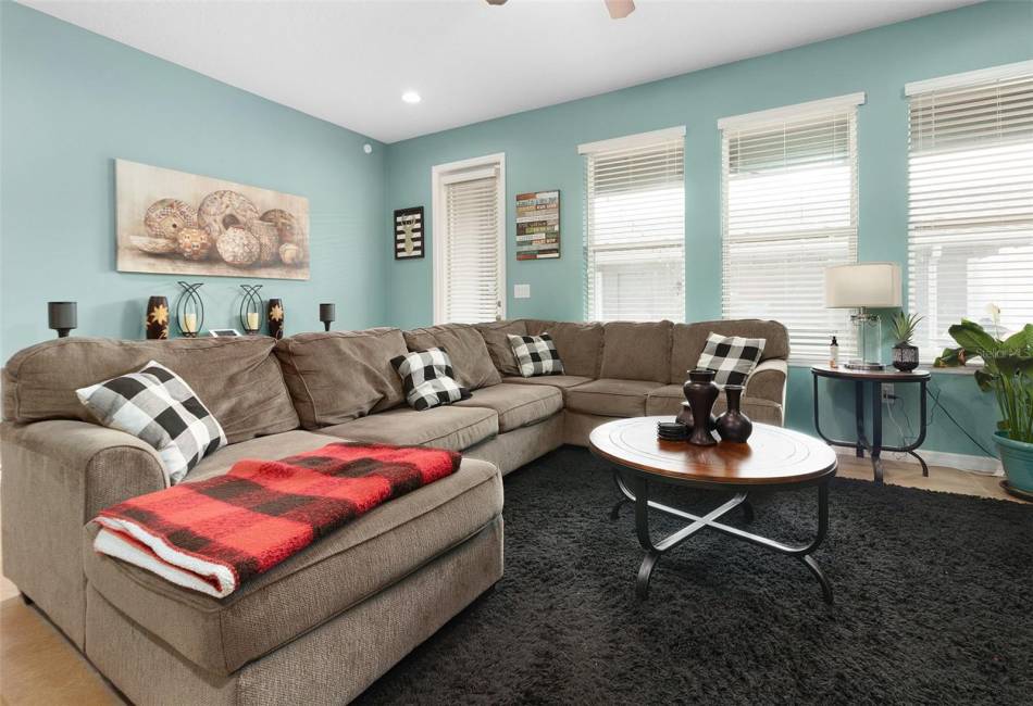 Living room features 3 windows for more natural light