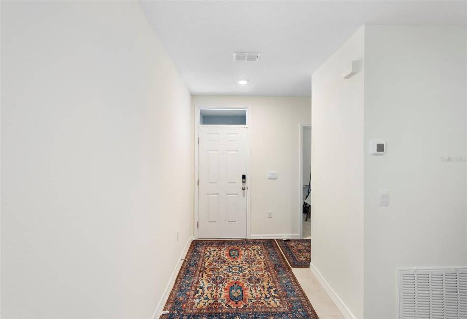 Foyer/Front Door with Hallway Leading to Laundry Room and Garage to the right.