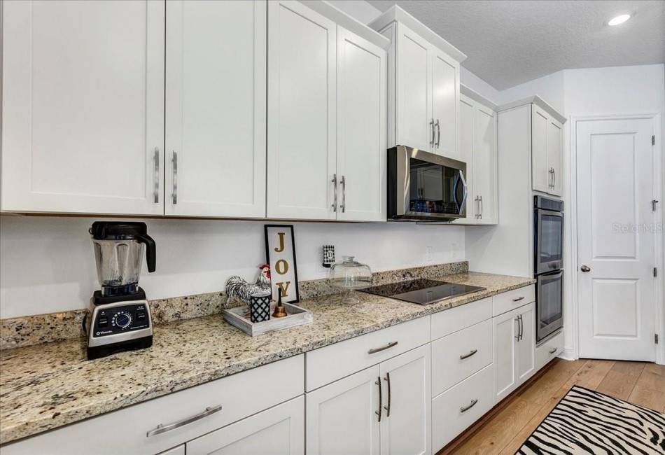 White kitchen with granite counter tops