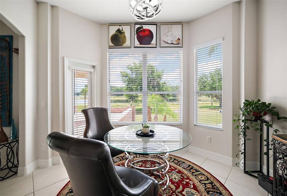 This casual dining area has views and a door to the rear patio.
